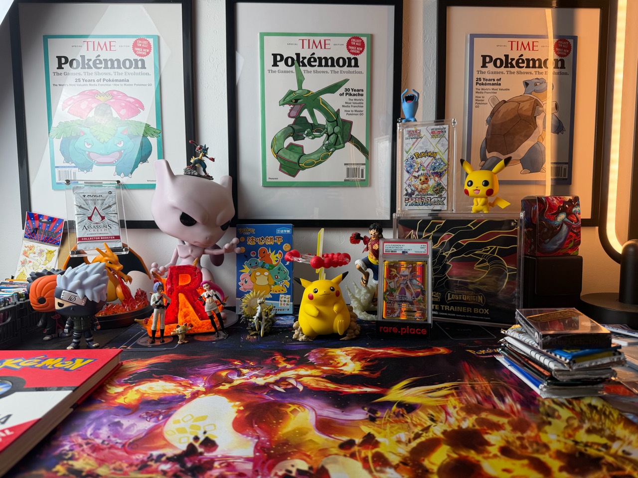 A closer look at the MrCards setup, including Pokémon figures, framed artwork and packs on the table.